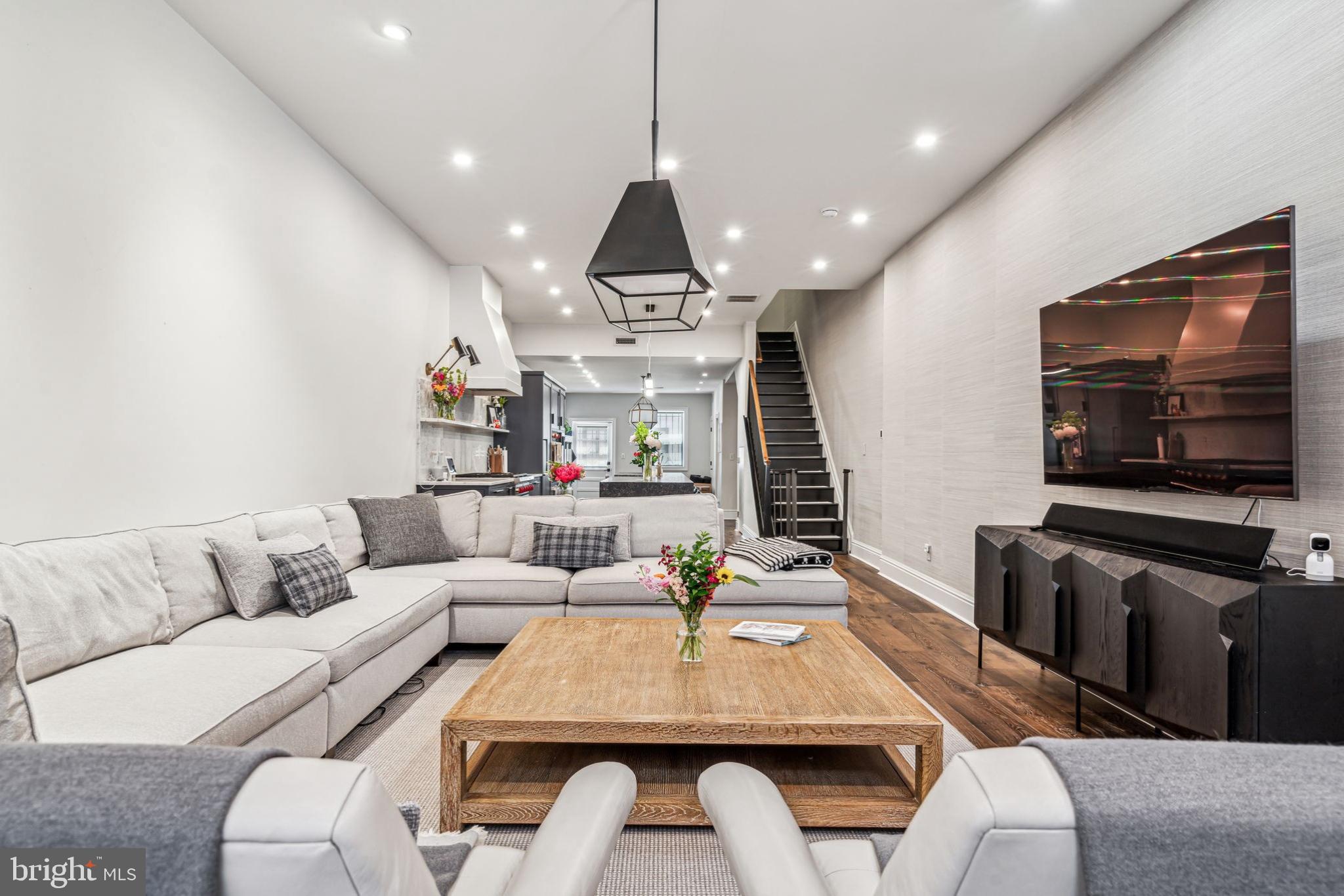 1710 Rittenhouse Square Philadelphia, PA 19103 - Photo 5 of 28 a living room with furniture a flat screen tv and kitchen view