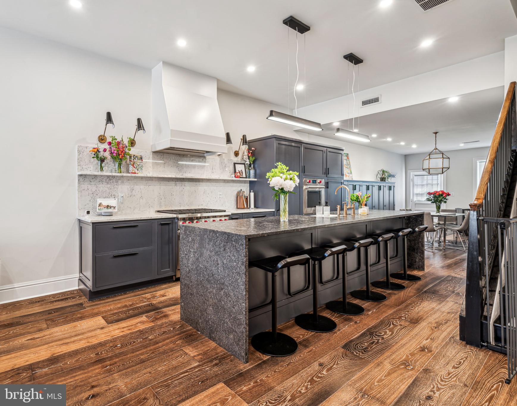 1710 Rittenhouse Square Philadelphia, PA 19103 - Photo 6 of 28 a kitchen with stainless steel appliances granite countertop a sink a stove and a wooden floor