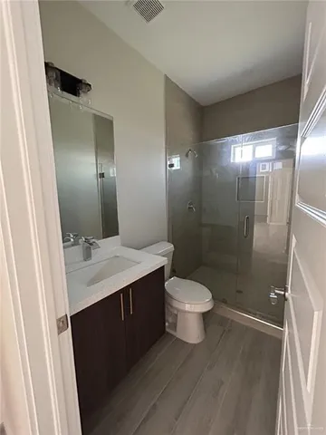 a bathroom with a granite countertop toilet and a sink