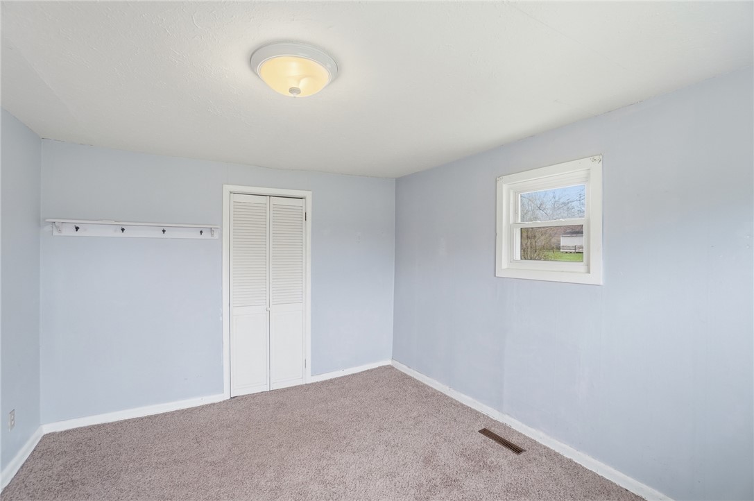 1166 West Sparrow Road Springfield, OH 45502 - Photo 15 of 40 This cozy bedroom features soft carpet and natural light, perfect for relaxation.