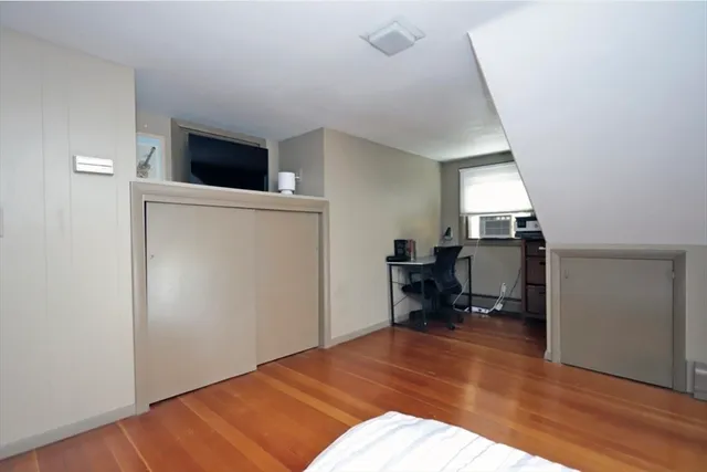 a bedroom with a bed and a workspace