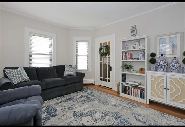 a living room with furniture and a book shelf