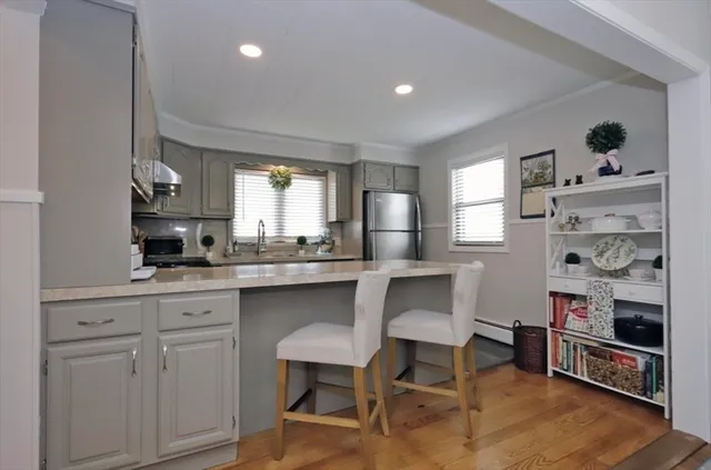 a kitchen with cabinets and chairs in it