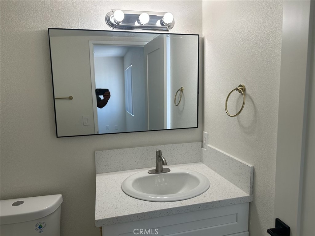 44155 10th Lancaster, CA 93534 - Photo 12 of 15 a bathroom with a sink and mirror