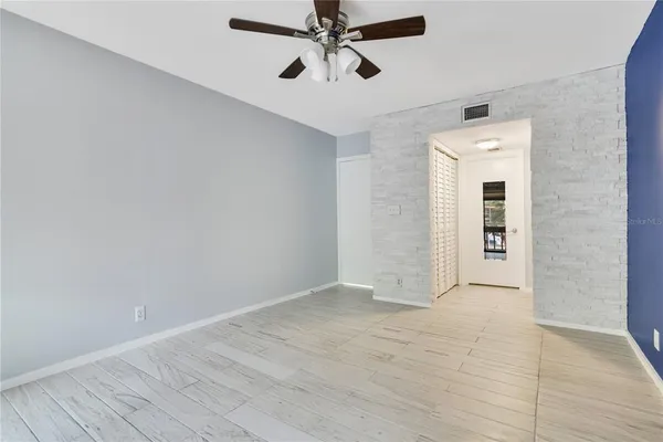 a white toilet sitting next to a bath tub and a shower