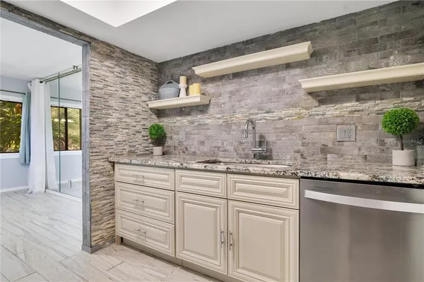 a kitchen with stainless steel appliances granite countertop a sink and a granite counter tops