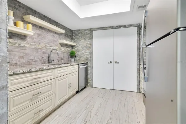 a bathroom with a granite countertop sink mirror and a shower
