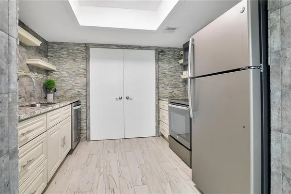 a kitchen with a refrigerator and a sink