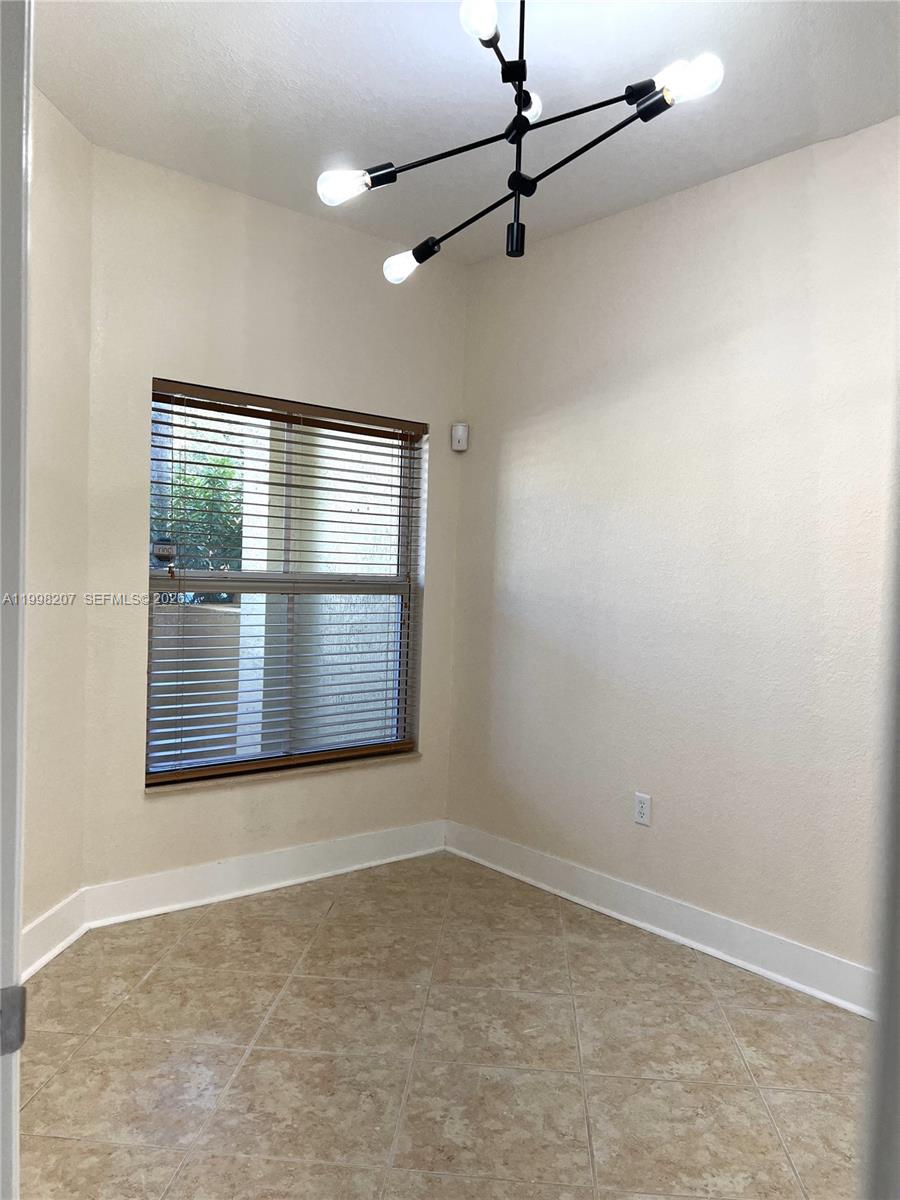 3377 Merrick Lane, Unit 707 Margate, FL 33063 - Photo 15 of 33 an empty room with a empty space and windows