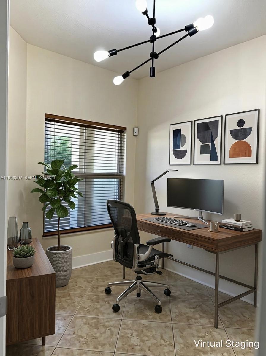 3377 Merrick Lane, Unit 707 Margate, FL 33063 - Photo 16 of 33 a workspace with furniture and a potted plant