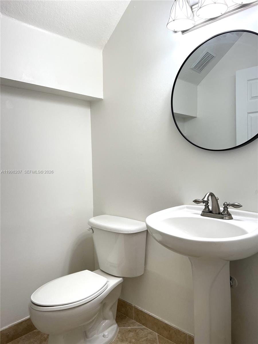 3377 Merrick Lane, Unit 707 Margate, FL 33063 - Photo 17 of 33 a white toilet sitting next to a bathroom sink