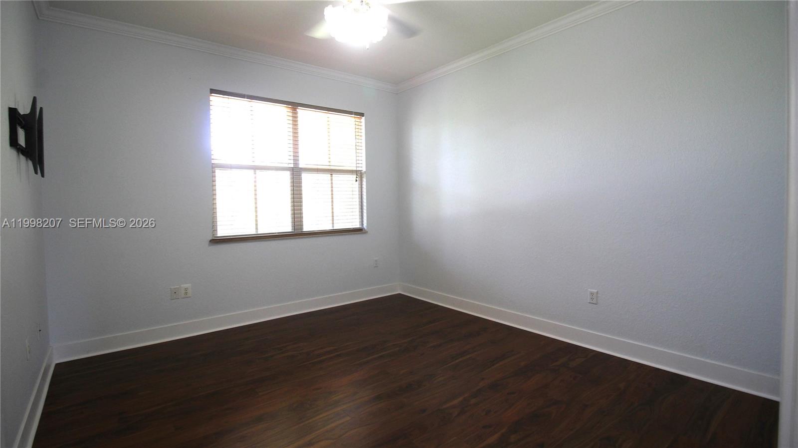 3377 Merrick Lane, Unit 707 Margate, FL 33063 - Photo 22 of 33 an empty room with wooden floor and windows
