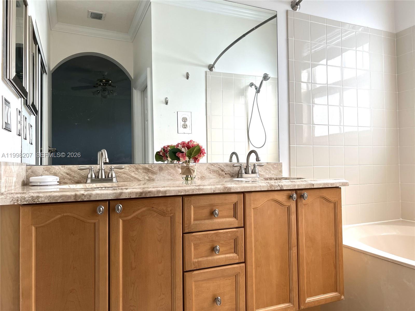 3377 Merrick Lane, Unit 707 Margate, FL 33063 - Photo 24 of 33 a bathroom with a granite countertop sink and a mirror