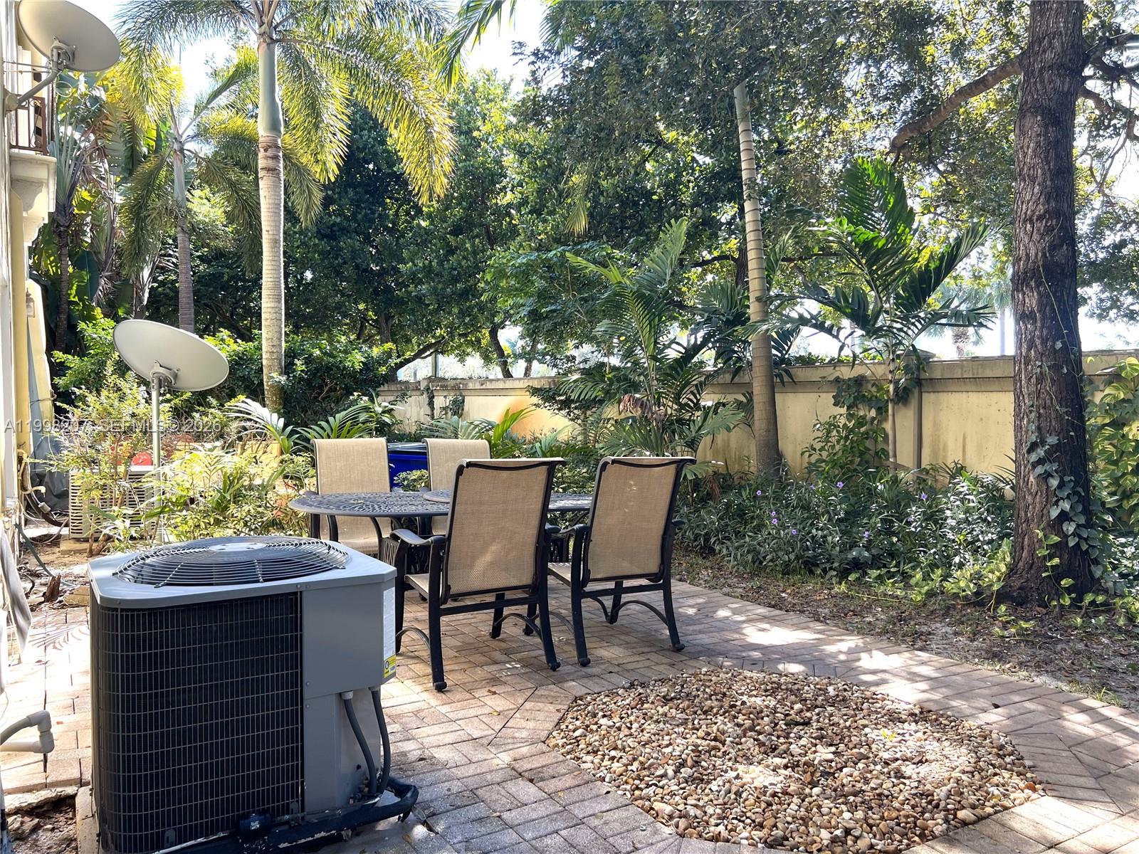 3377 Merrick Lane, Unit 707 Margate, FL 33063 - Photo 31 of 33 a view of a patio with table and chairs and potted plants