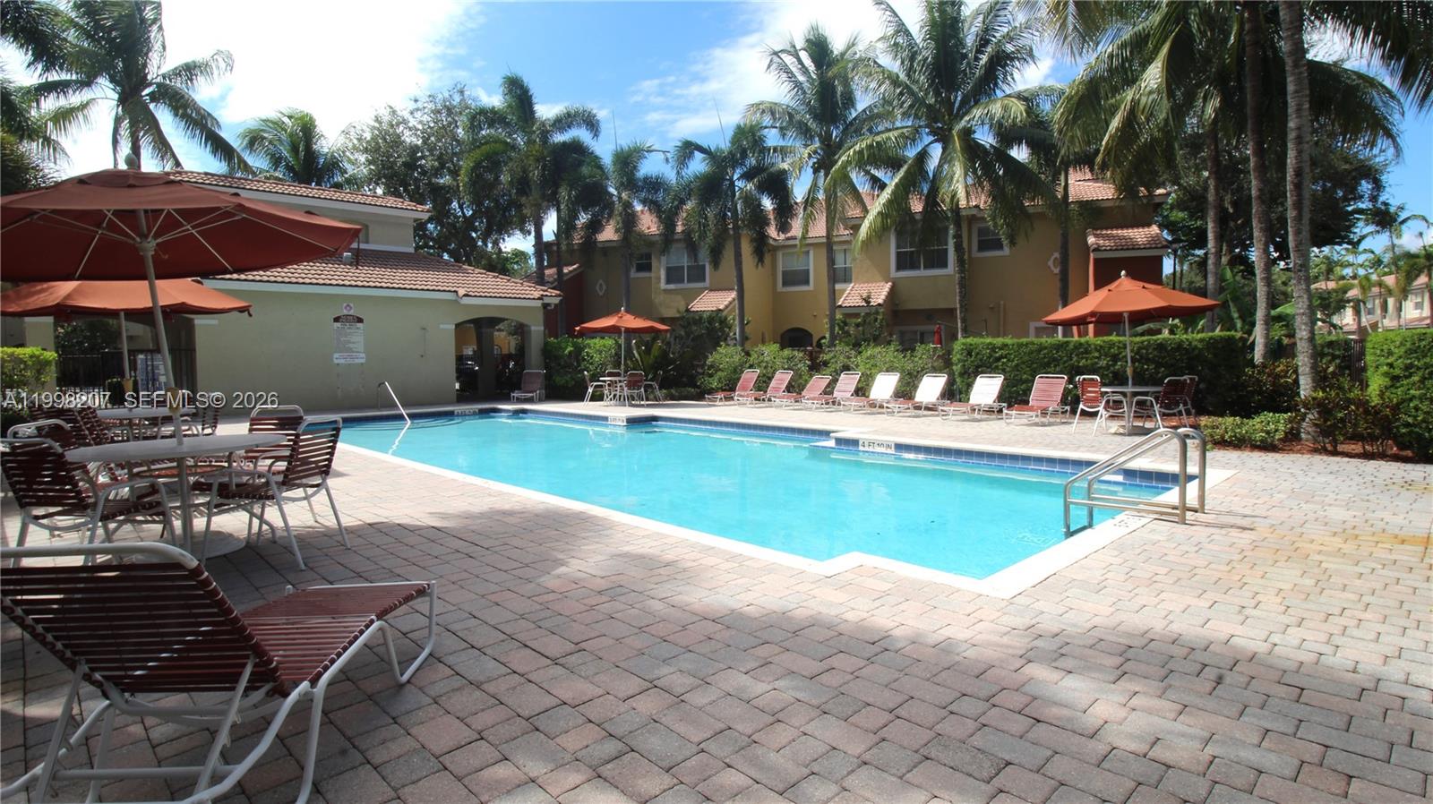 3377 Merrick Lane, Unit 707 Margate, FL 33063 - Photo 32 of 33 a swimming pool with outdoor seating and yard