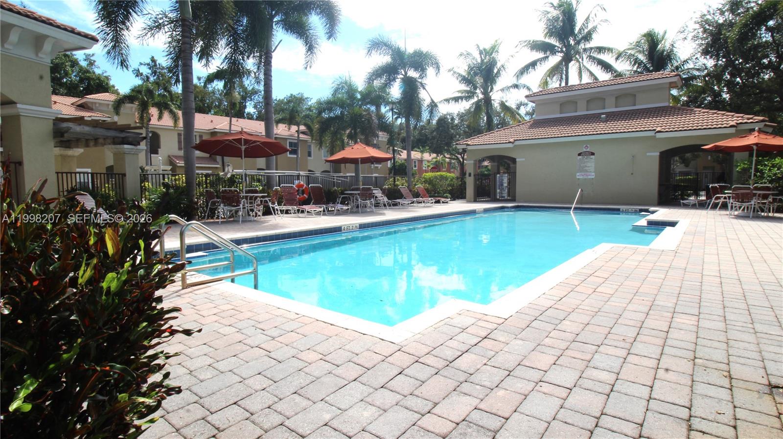 3377 Merrick Lane, Unit 707 Margate, FL 33063 - Photo 33 of 33 a view of a house with backyard swimming pool and sitting area