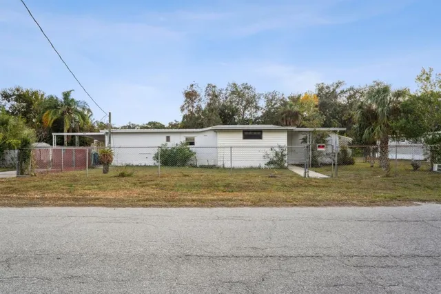 a view of back yard and swimming pool