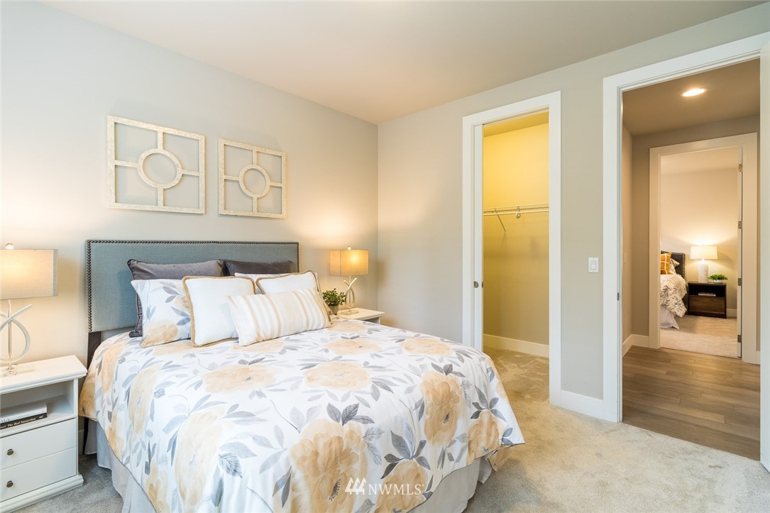 7155 Teal Loop Gig Harbor, WA 98335 - Photo 12 of 40 a bedroom with a bed and a painting on the wall