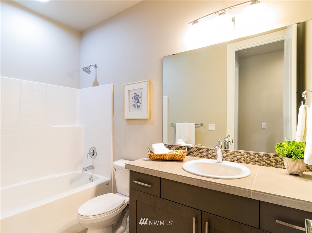 7155 Teal Loop Gig Harbor, WA 98335 - Photo 13 of 40 a bathroom with a sink a toilet a tub and shower