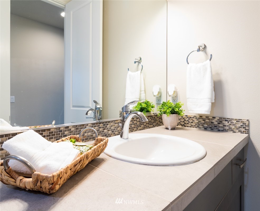 7155 Teal Loop Gig Harbor, WA 98335 - Photo 14 of 40 a bath room with a sink and a mirror