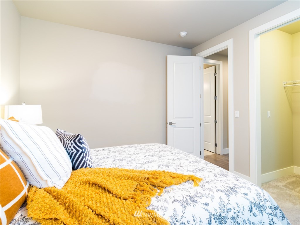 7155 Teal Loop Gig Harbor, WA 98335 - Photo 17 of 40 a bedroom with a bed and a lamp