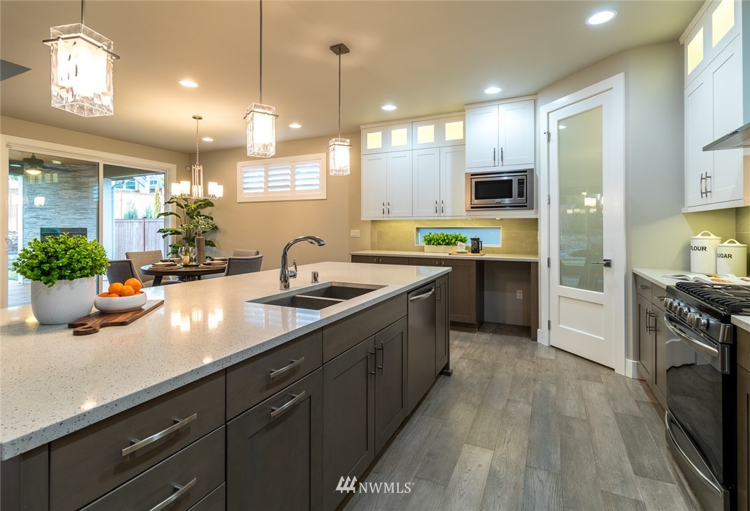 7155 Teal Loop Gig Harbor, WA 98335 - Photo 20 of 40 a kitchen with lots of counter space sink and appliances