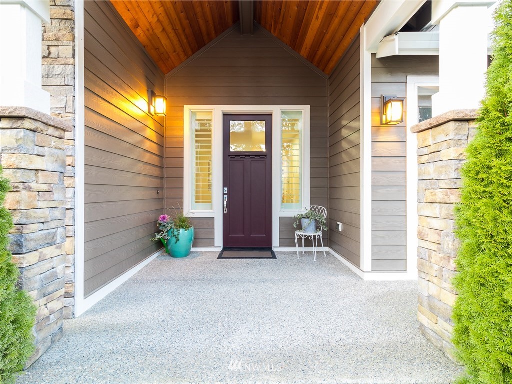 7155 Teal Loop Gig Harbor, WA 98335 - Photo 2 of 40 a view of a house with a small yard and a patio