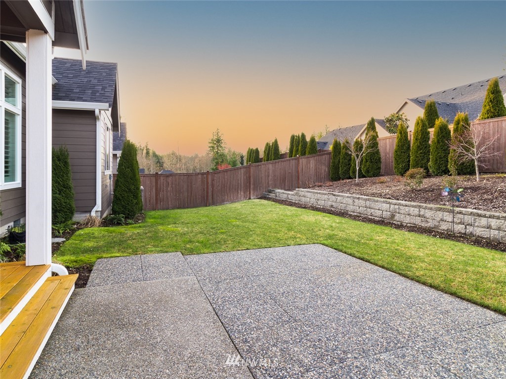7155 Teal Loop Gig Harbor, WA 98335 - Photo 25 of 40 a view of a backyard with a garden and entertaining space