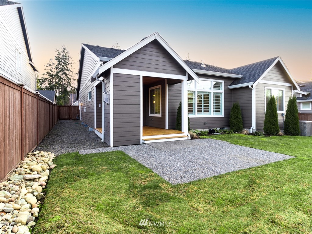7155 Teal Loop Gig Harbor, WA 98335 - Photo 27 of 40 a front view of a house with a garden and yard