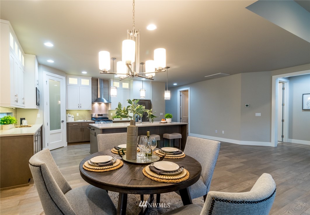 7155 Teal Loop Gig Harbor, WA 98335 - Photo 29 of 40 a kitchen with a dining table and chairs
