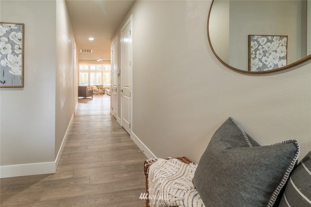 7155 Teal Loop Gig Harbor, WA 98335 - Photo 3 of 40 a view of a hallway with furniture and wooden floor