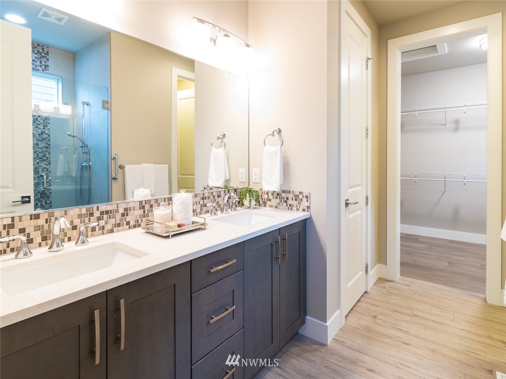 7155 Teal Loop Gig Harbor, WA 98335 - Photo 33 of 40 a bathroom with a double vanity sink and a mirror