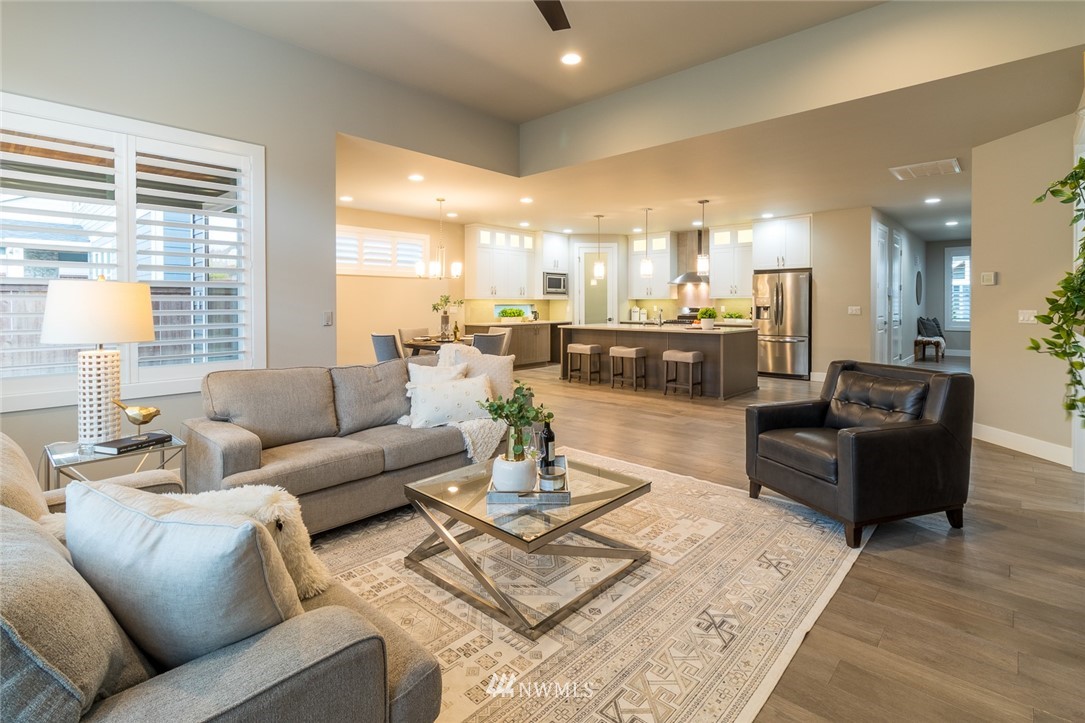 7155 Teal Loop Gig Harbor, WA 98335 - Photo 5 of 40 a living room with furniture and a large window