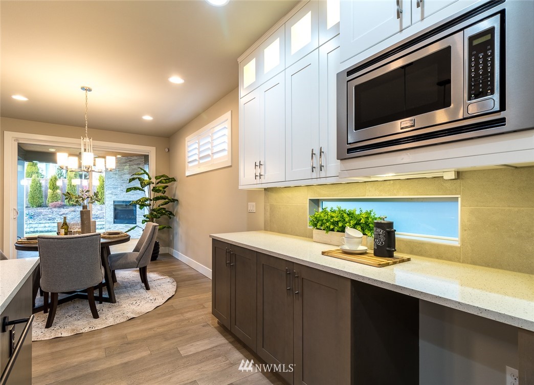 7155 Teal Loop Gig Harbor, WA 98335 - Photo 7 of 40 a kitchen with stainless steel appliances a stove a sink and a microwave