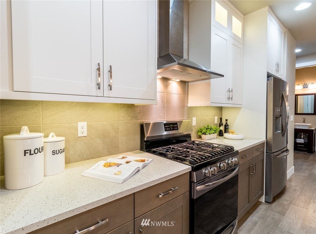 7155 Teal Loop Gig Harbor, WA 98335 - Photo 8 of 40 a kitchen with stainless steel appliances a stove a sink and a refrigerator