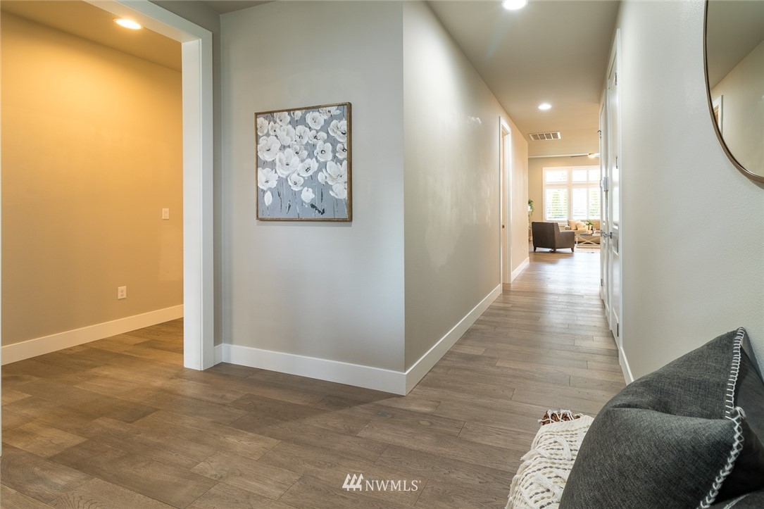 7155 Teal Loop Gig Harbor, WA 98335 - Photo 10 of 40 a view of a hallway with furniture and wooden floor
