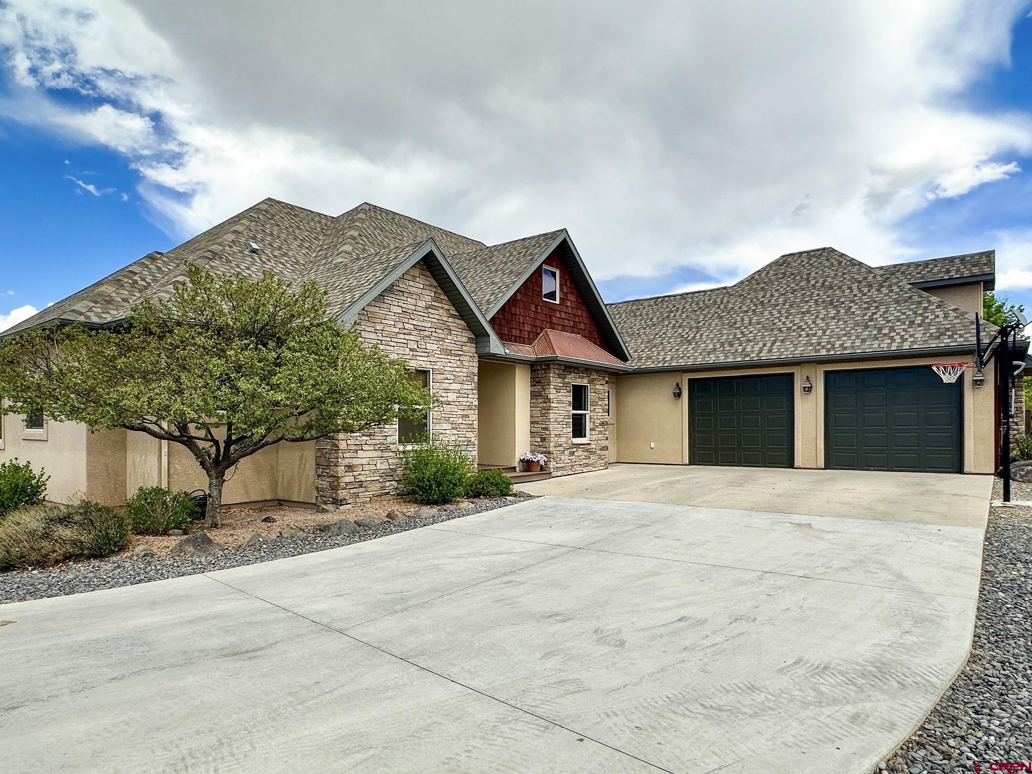 1787 Roubideau Street Delta, CO 81416 - Photo 1 of 35 a front view of a house with a yard and garage