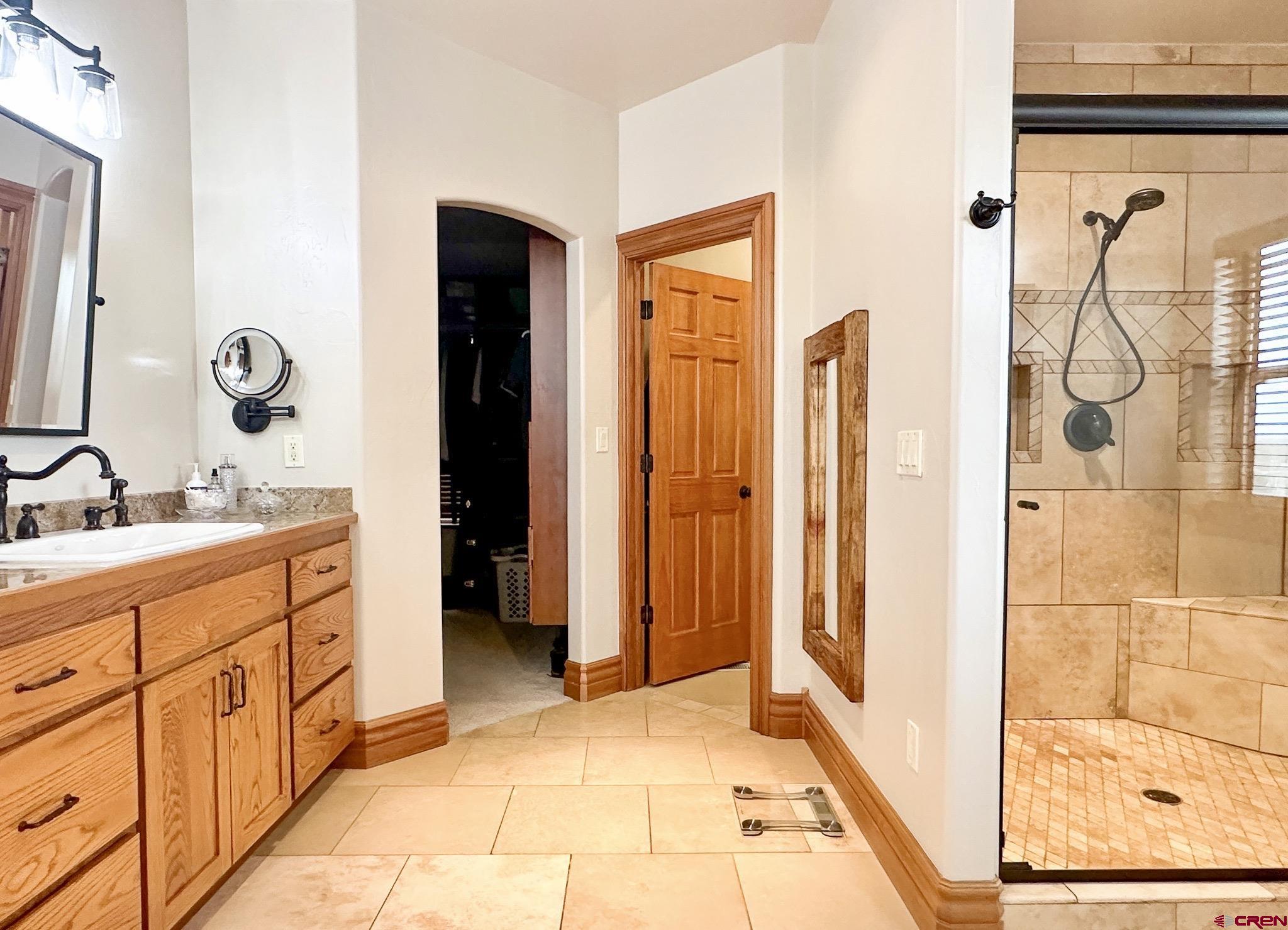 1787 Roubideau Street Delta, CO 81416 - Photo 20 of 35 a bathroom with a double vanity sink and a mirror