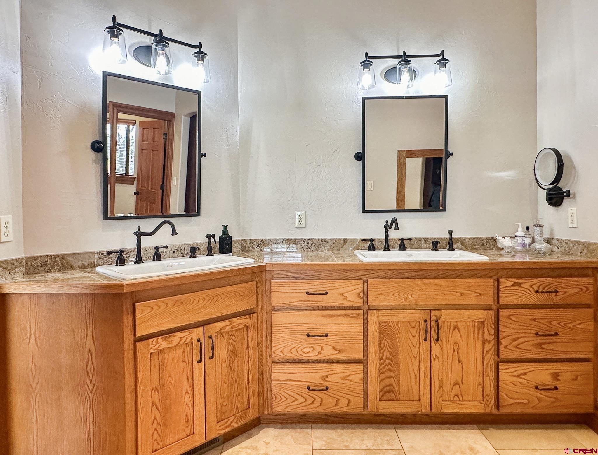 1787 Roubideau Street Delta, CO 81416 - Photo 21 of 35 a bathroom with a sink double vanity and a mirror