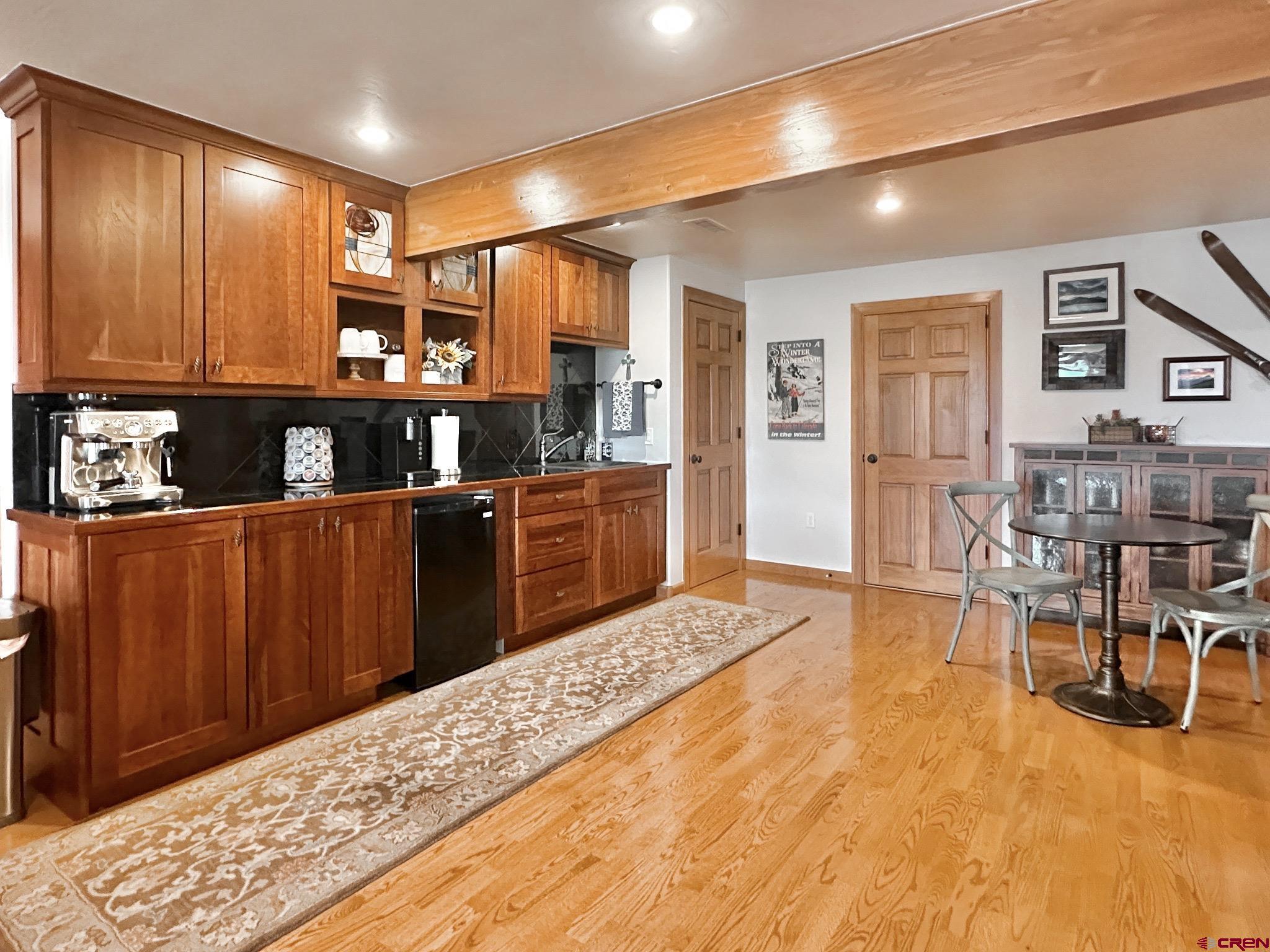 1787 Roubideau Street Delta, CO 81416 - Photo 24 of 35 a living room with stainless steel appliances kitchen island granite countertop furniture and wooden floor