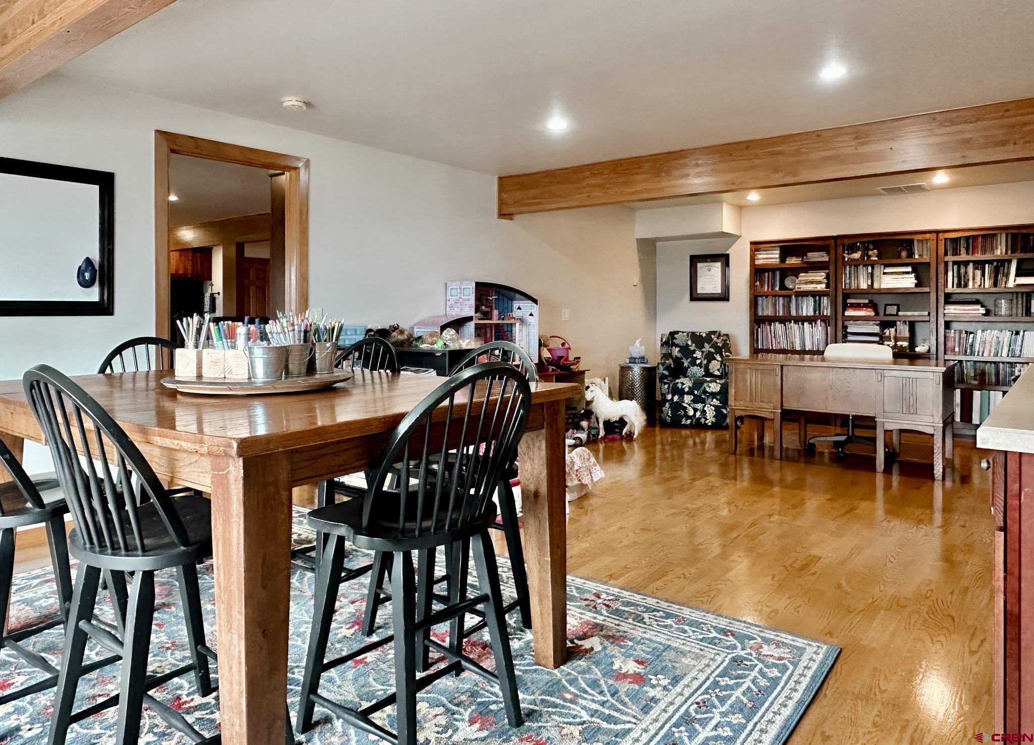 1787 Roubideau Street Delta, CO 81416 - Photo 26 of 35 a dining hall with furniture a rug and white walls