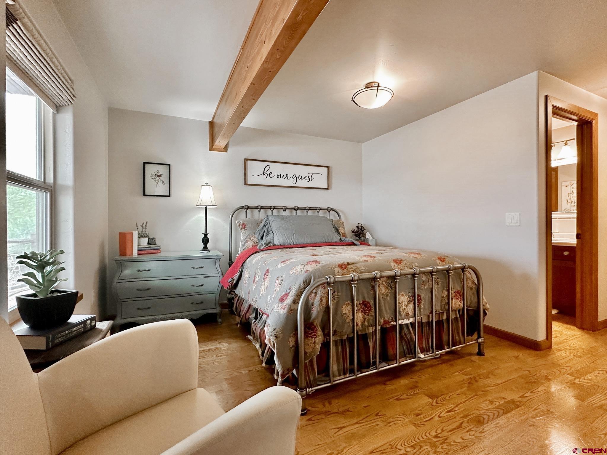 1787 Roubideau Street Delta, CO 81416 - Photo 27 of 35 a bed sitting in a bedroom next to a window