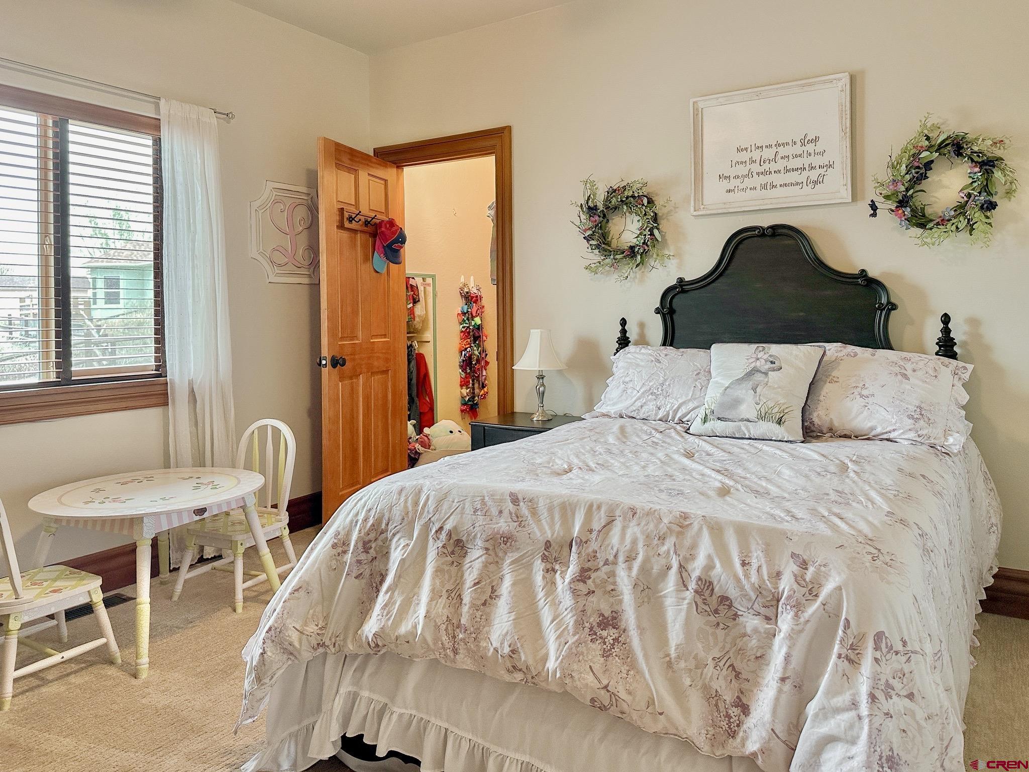 1787 Roubideau Street Delta, CO 81416 - Photo 29 of 35 a bedroom with a bed and a painting on the wall