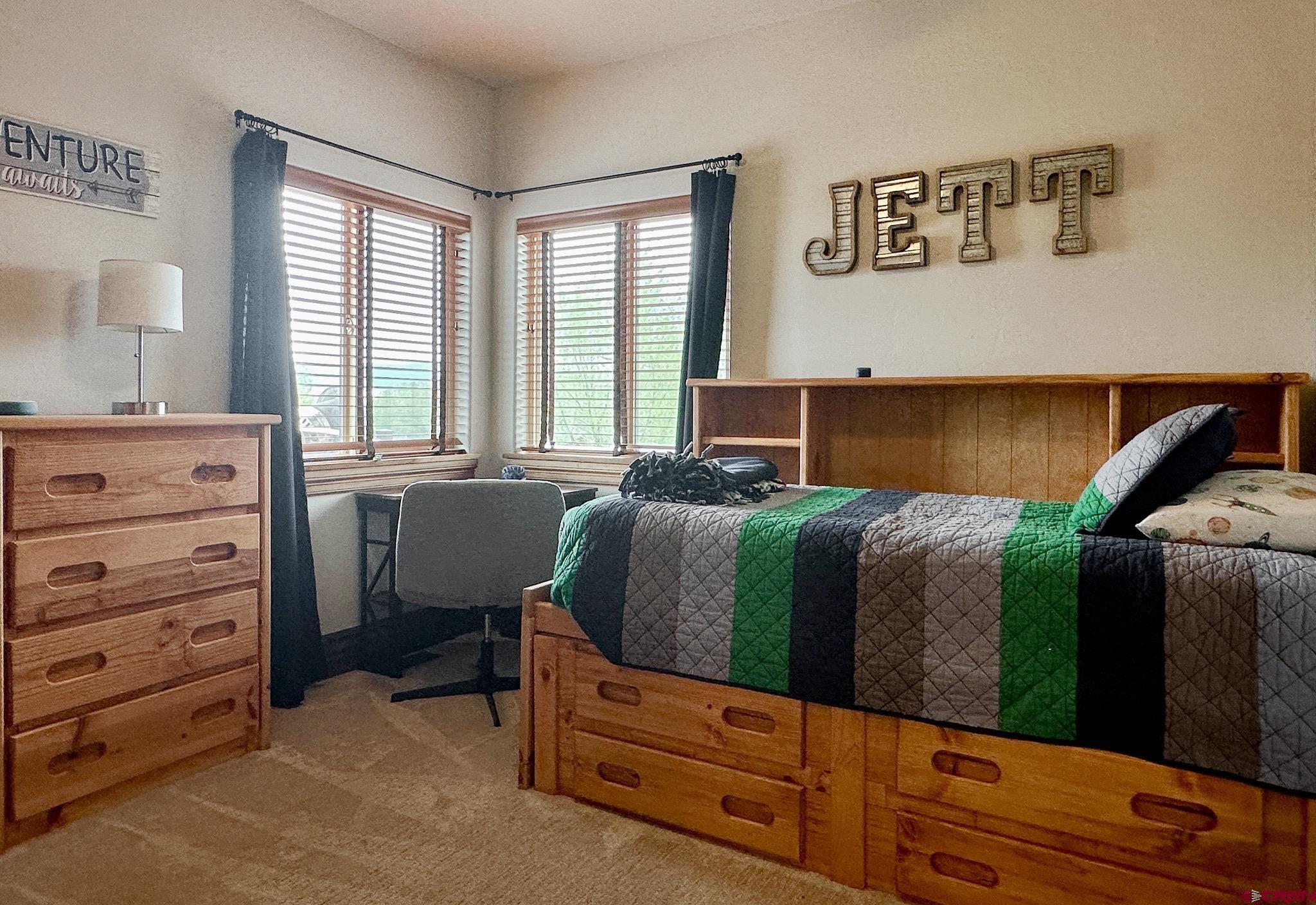 1787 Roubideau Street Delta, CO 81416 - Photo 31 of 35 a bedroom with a bed and a window