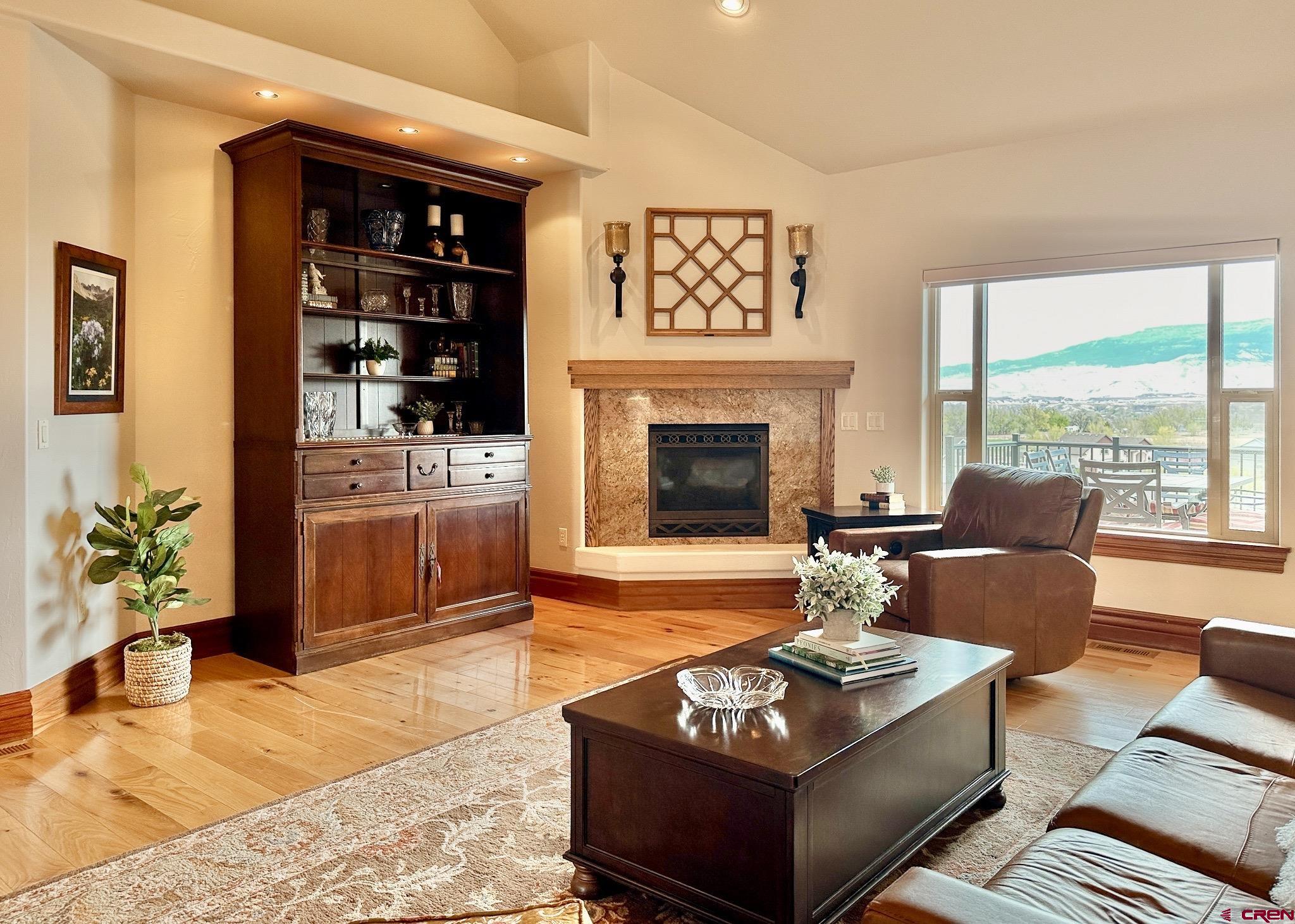 1787 Roubideau Street Delta, CO 81416 - Photo 10 of 35 a living room with furniture a fireplace and a floor to ceiling window
