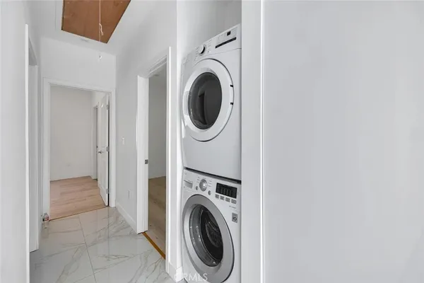 a view of a hallway with washer and dryer