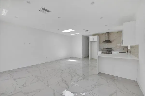a kitchen with granite countertop a sink and cabinets