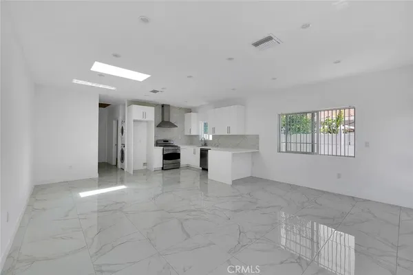 a view of kitchen with windows and refrigerator