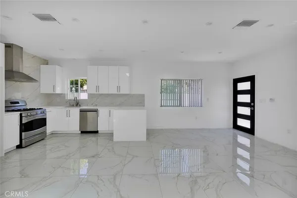 a kitchen with stainless steel appliances cabinets a sink and a stove