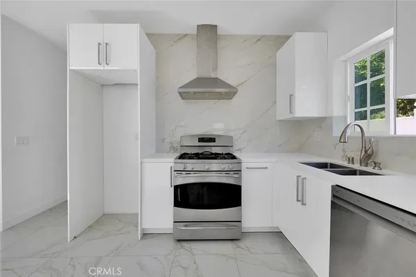 a kitchen with a stove and a sink